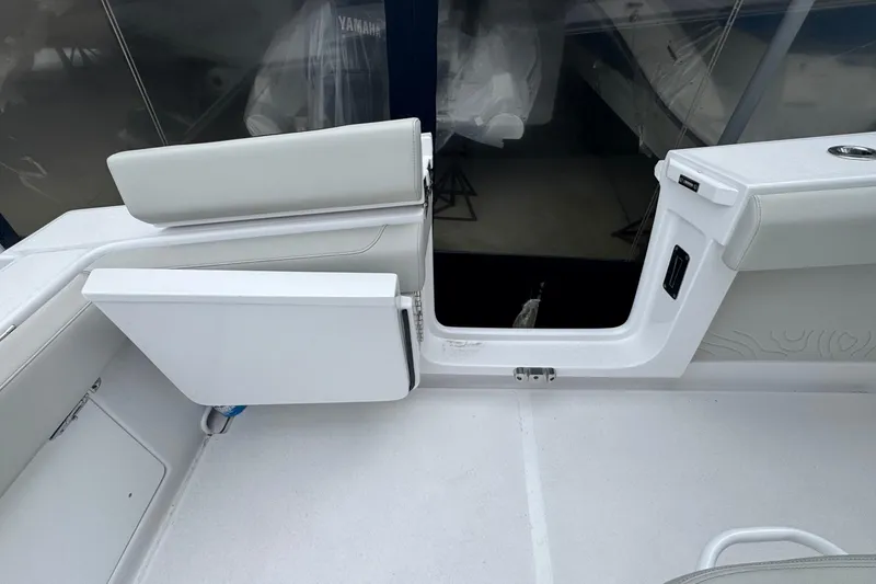 Slide: The Image of Interior view of a 2026 Jupiter 30 boat, featuring sleek white seating and modern design. - 24