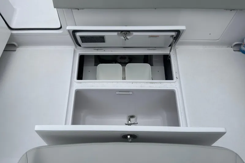 Slide: The Image of Open storage compartments on a 2026 Jupiter 30 boat deck. - 26