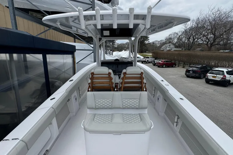 Slide: The Image of 2026 Jupiter 30 boat with sleek design and comfortable seating, docked in a marina. - 28