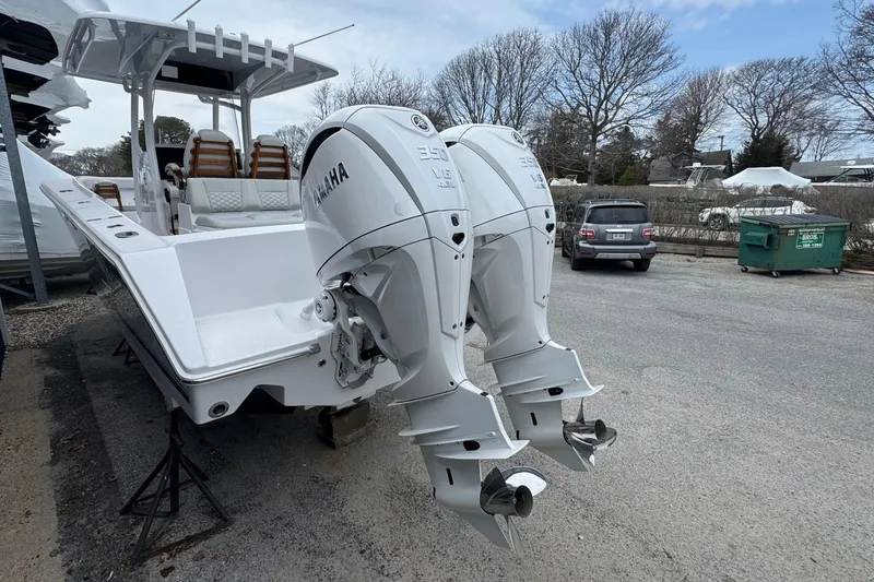 Slide: The Image of 2026 Jupiter 30 boat with dual Yamaha outboard engines in a parking area. - 3