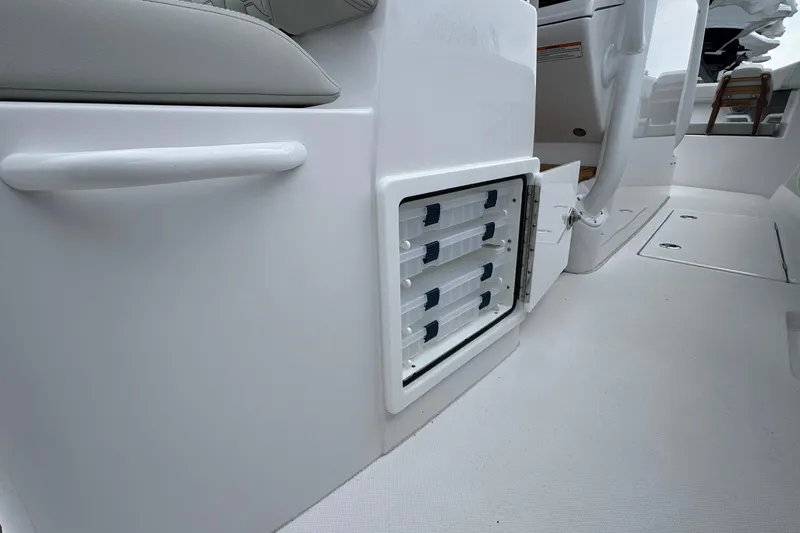 Slide: The Image of Storage compartment on a 2026 Jupiter 30 boat, featuring sleek white interior design. - 32