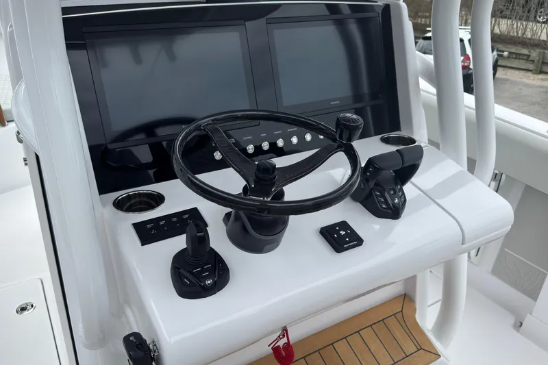 Slide: The Image of Helm of 2026 Jupiter 30 boat with dual screens and modern controls. - 35
