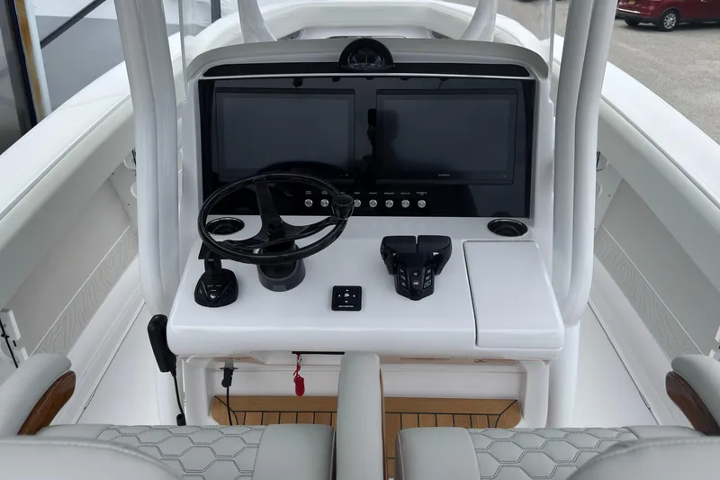 Slide: The Image of Helm of 2026 Jupiter 30 boat with dual screens and modern controls. - 36