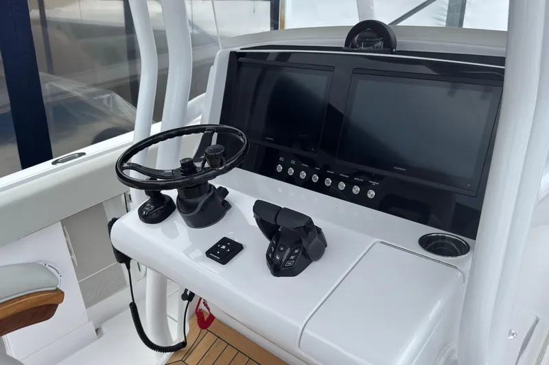 Slide: The Image of Helm of 2026 Jupiter 30 boat with dual screens and steering wheel. - 37