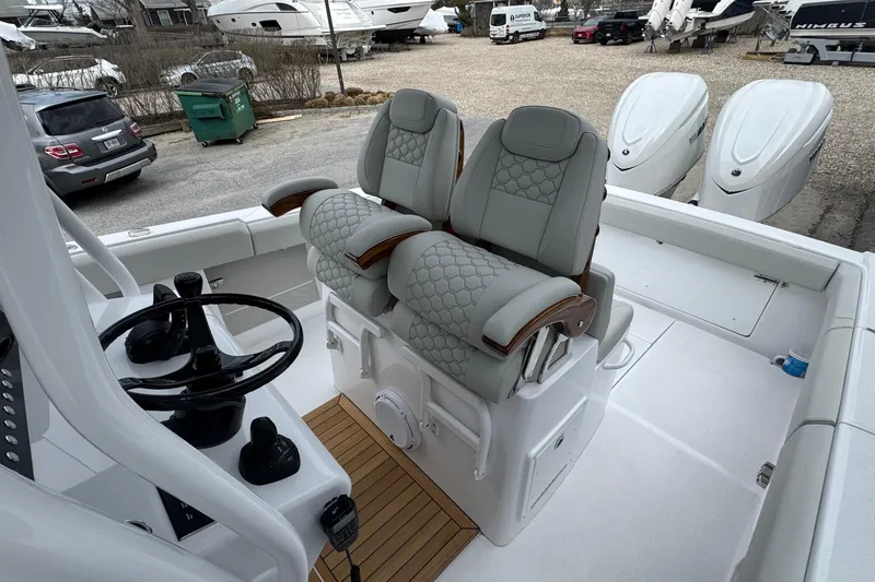 Slide: The Image of Luxury seating and helm of 2026 Jupiter 30 boat with twin engines. - 38