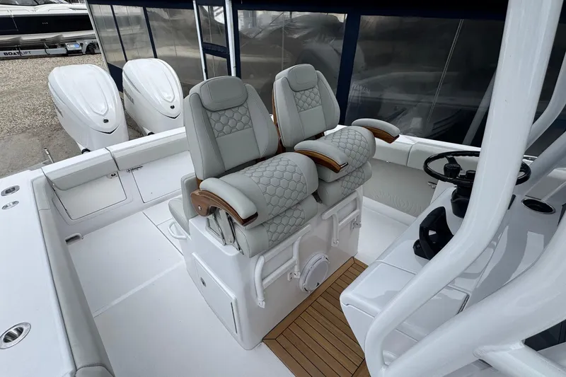 Slide: The Image of Luxury seating and helm of 2026 Jupiter 30 boat, featuring modern design and twin engines. - 40