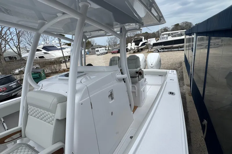 Slide: The Image of 2026 Jupiter 30 boat with sleek design, parked in a marina with other vessels. - 47