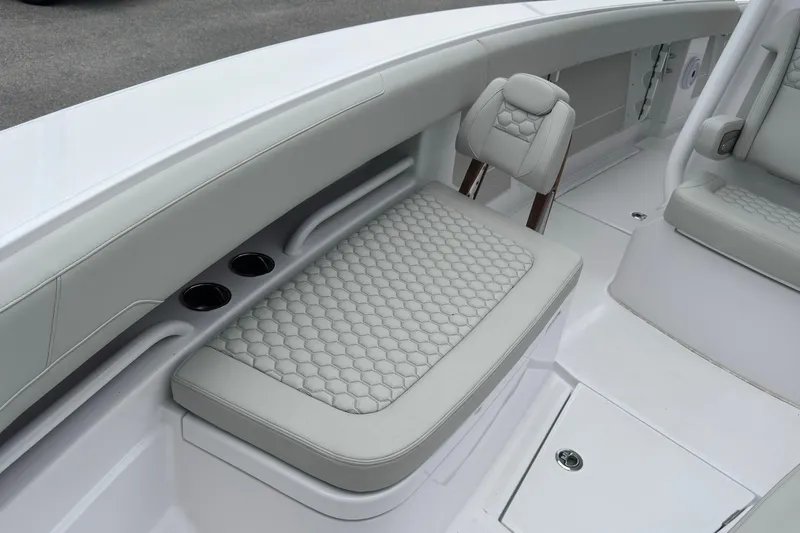 Slide: The Image of Luxurious seating on 2026 Jupiter 30 boat with hexagonal pattern and cup holders. - 53