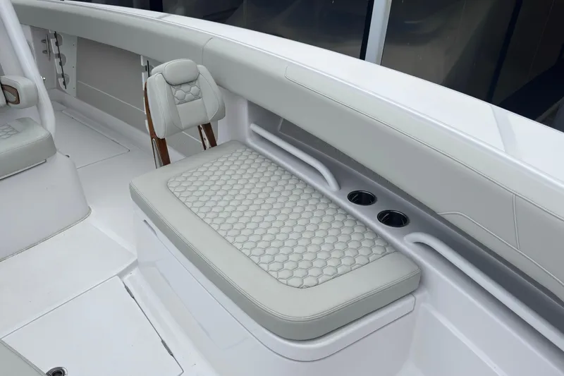 Slide: The Image of Luxurious seating on a 2026 Jupiter 30 boat, featuring elegant upholstery and cup holders. - 54