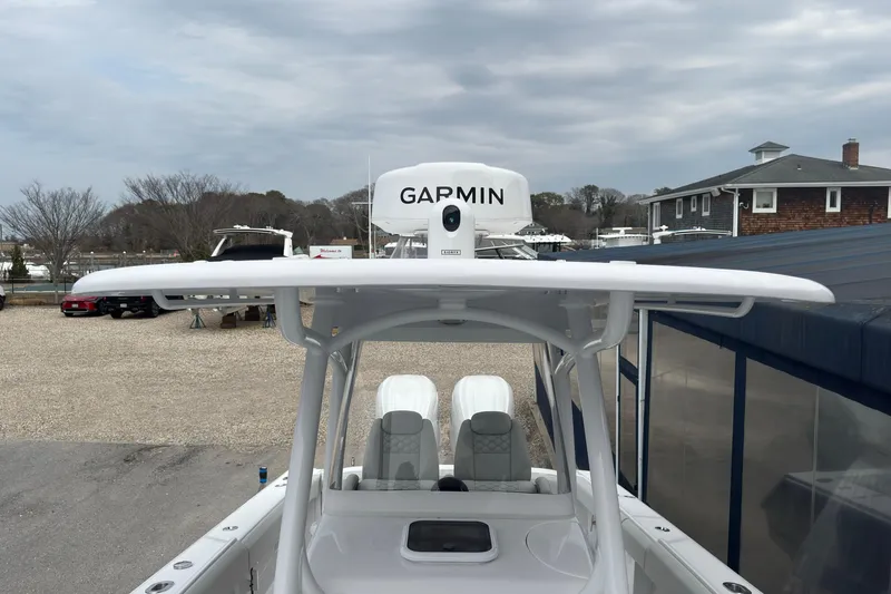 Slide: The Image of 2026 Jupiter 30 boat with Garmin radar, docked near buildings under cloudy sky. - 55