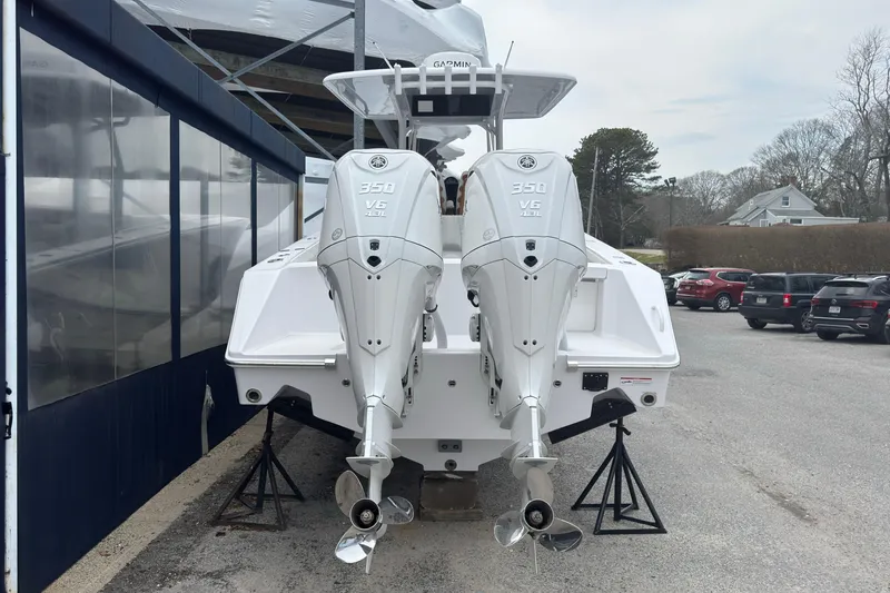 Slide: The Image of 2026 Jupiter 30 boat with dual 350 V6 engines, parked outdoors. - 6