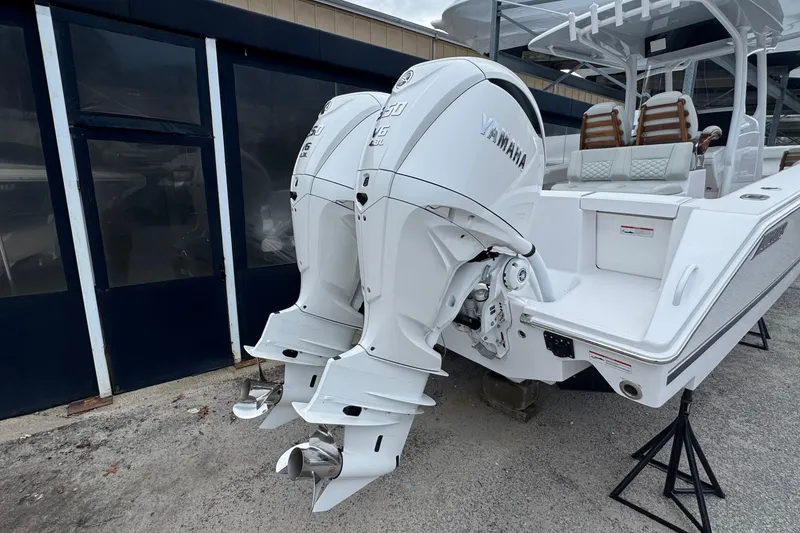 Slide: The Image of 2026 Jupiter 30 boat with dual Yamaha outboard engines, docked on stands. - 7