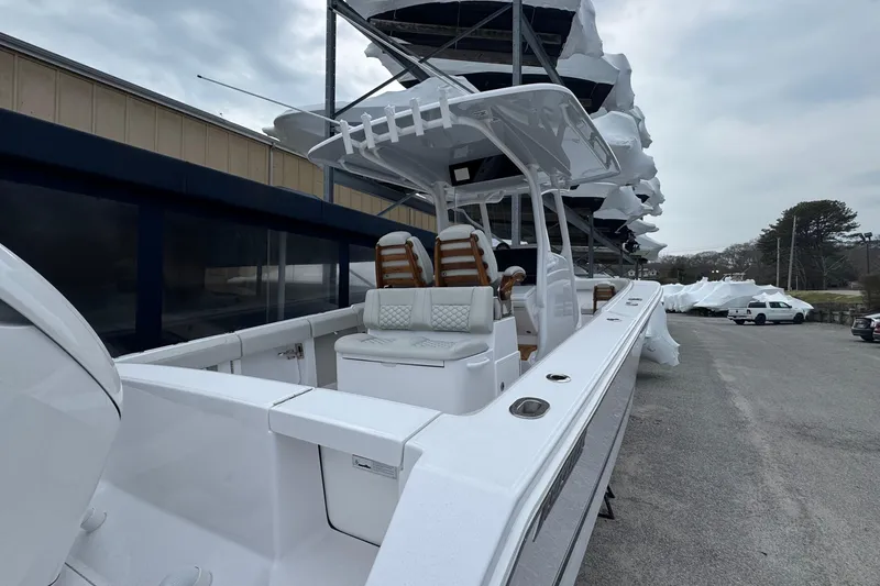 Slide: The Image of 2026 Jupiter 30 boat with sleek design, docked outdoors under cloudy sky. - 8