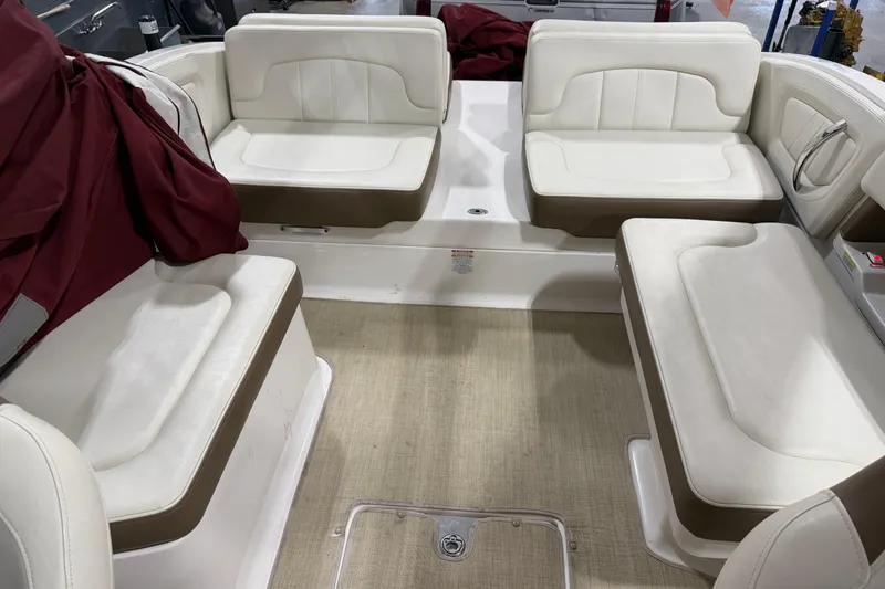 Slide: The Image of 2014 Chaparral 257 SSX boat interior with white and brown seating arrangement. - 15