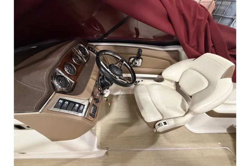 Slide: The Image of 2014 Chaparral 257 SSX boat cockpit with beige leather seat and control panel. - 16