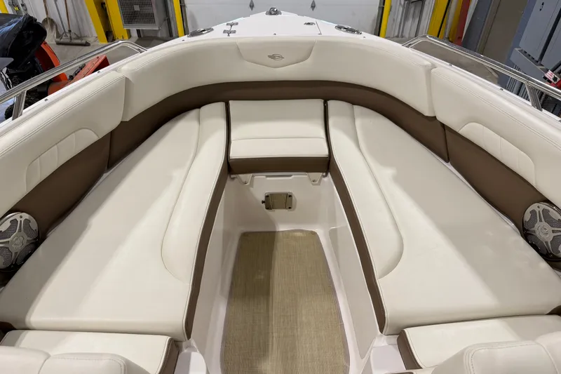 Slide: The Image of 2014 Chaparral 257 SSX boat interior with white and brown seating. - 17