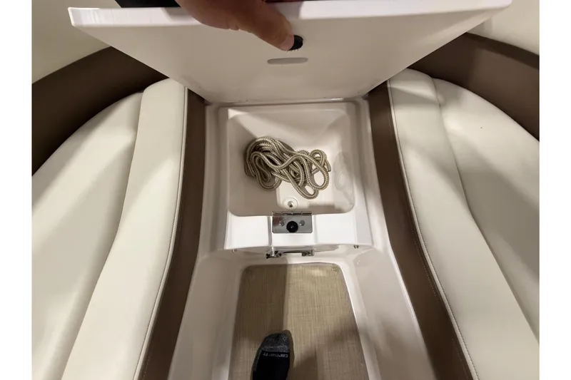 Slide: The Image of Storage compartment in a 2014 Chaparral 257 SSX boat with coiled rope. - 18