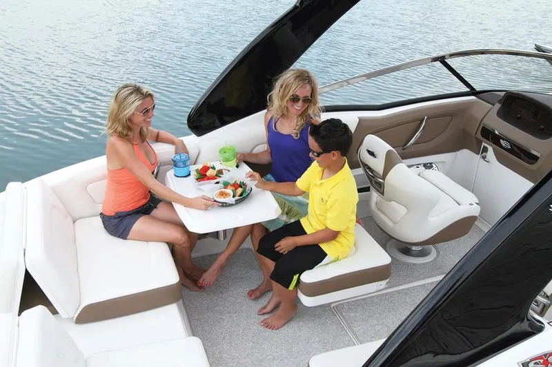 Slide: The Image of Manufacturer Provided Image: 2014 Chaparral 257 SSX boat interior with people dining on the water. - 26