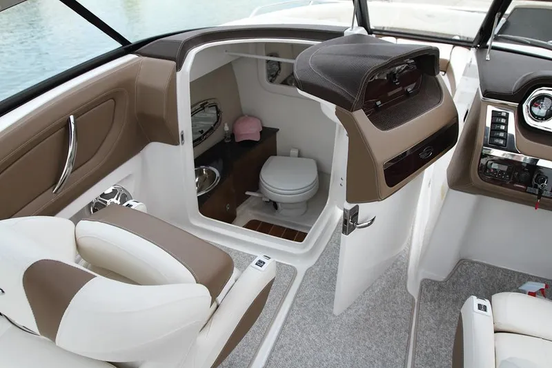 Slide: The Image of White leather seating on a 2014 Chaparral 257 SSX boat, in a workshop setting. - 8