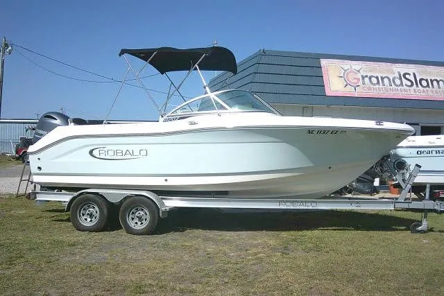 The Image of 2019 Robalo R207 Dual Console boat on trailer, parked outdoors. - 1