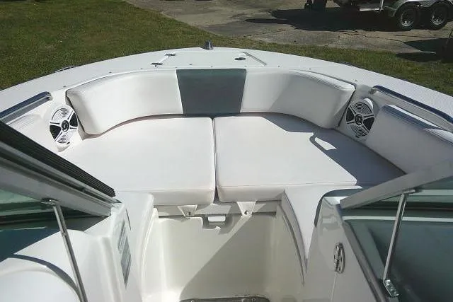 Slide: The Image of 2019 Robalo R207 Dual Console boat with white cushioned seating and speakers. - 16