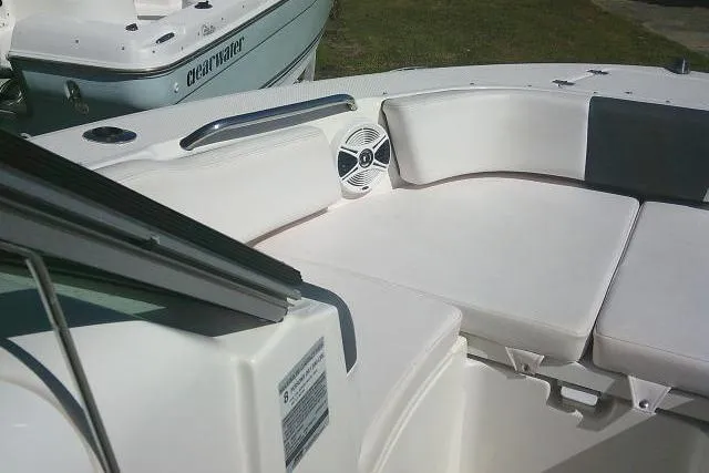 Slide: The Image of 2019 Robalo R207 Dual Console boat interior with cushioned seating and speaker. - 17