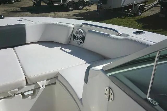 Slide: The Image of 2019 Robalo R207 Dual Console boat interior with cushioned seating and speaker. - 18