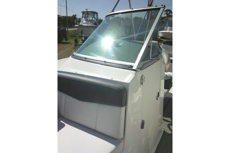 Slide: The Image of 2019 Robalo R207 Dual Console boat with windshield and seating, parked outdoors. - 21