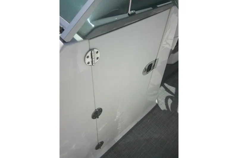 Slide: The Image of 2019 Robalo R207 Dual Console boat door with stainless steel hinges and latch. - 23