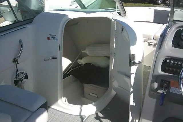Slide: The Image of 2019 Robalo R207 Dual Console boat interior with open storage compartment. - 27