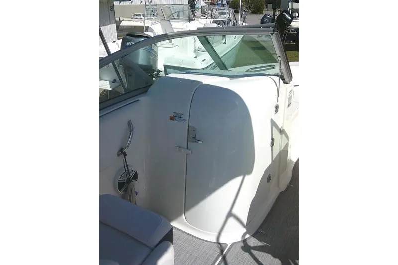 Slide: The Image of 2019 Robalo R207 Dual Console boat interior with seating and storage compartment. - 28