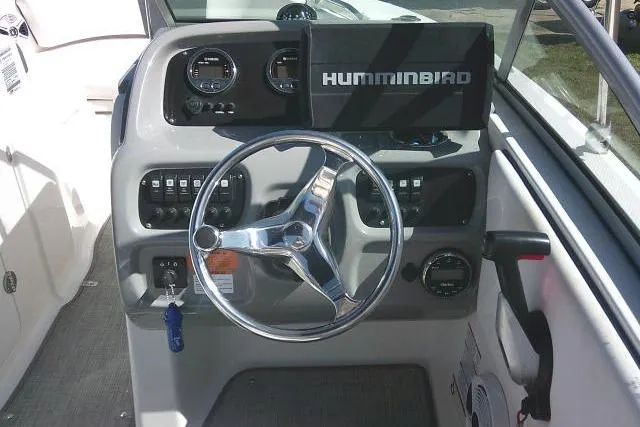 Slide: The Image of 2019 Robalo R207 Dual Console boat dashboard with steering wheel and Humminbird electronics. - 30