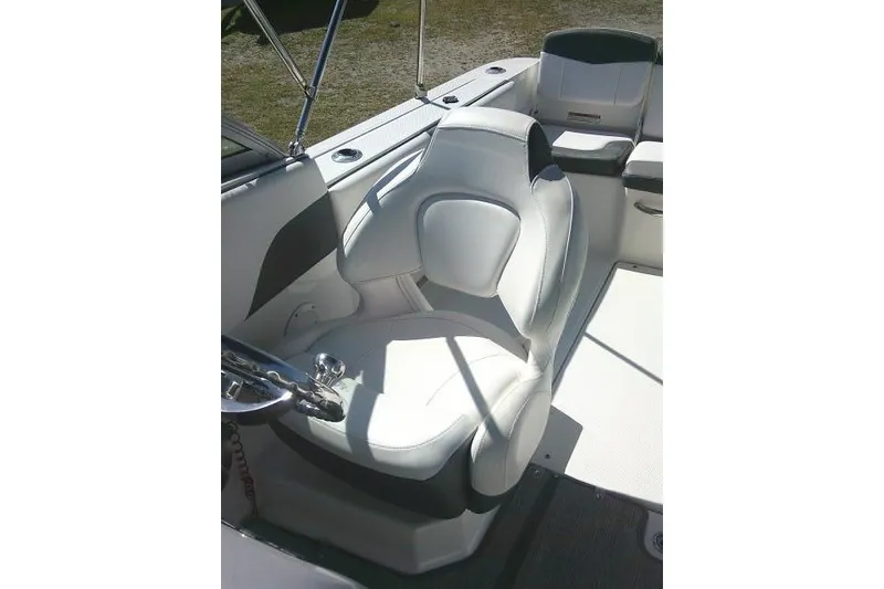 Slide: The Image of 2019 Robalo R207 Dual Console boat interior with white seating and steering wheel. - 32