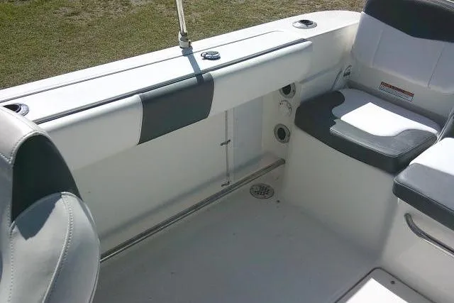 Slide: The Image of 2019 Robalo R207 Dual Console boat interior with seating and storage compartments. - 36