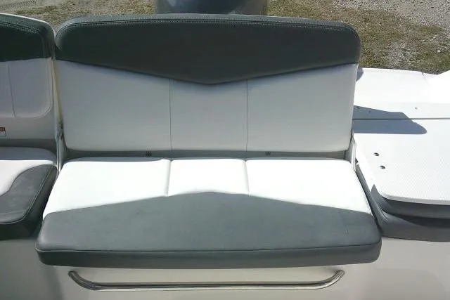 Slide: The Image of 2019 Robalo R207 Dual Console boat seat, featuring gray and white upholstery. - 38