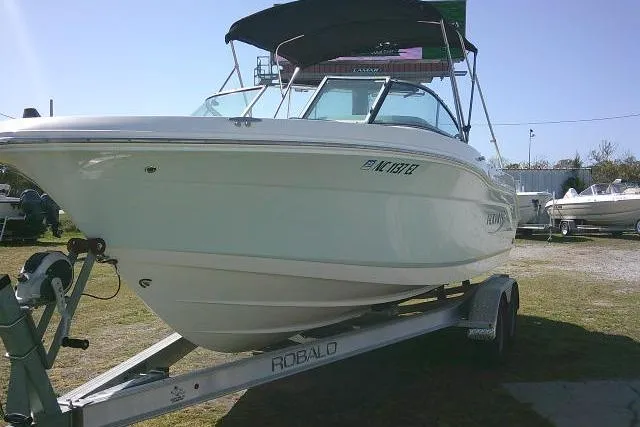 Slide: The Image of 2019 Robalo R207 Dual Console boat on trailer, parked outdoors. - 4