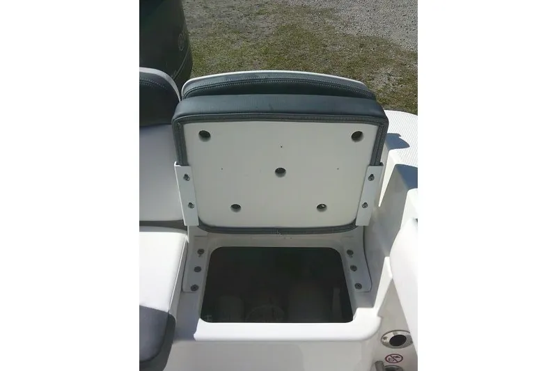 Slide: The Image of 2019 Robalo R207 Dual Console seat storage compartment open, showcasing interior space. - 41