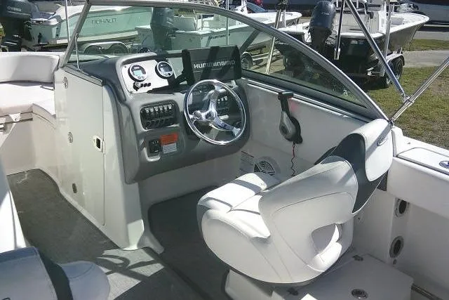 Slide: The Image of 2019 Robalo R207 Dual Console boat interior with steering wheel and dashboard controls. - 42