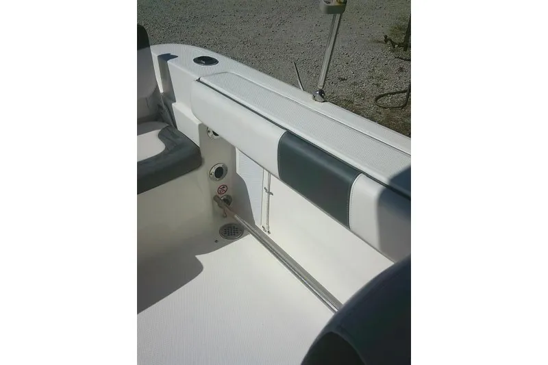 Slide: The Image of 2019 Robalo R207 Dual Console interior detail with seating and rod holder. - 46