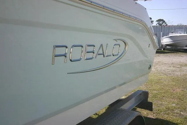 Slide: The Image of 2019 Robalo R207 Dual Console boat side view with logo. - 7