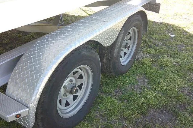 Slide: The Image of Trailer wheels for 2019 Robalo R207 Dual Console on grass. - 8