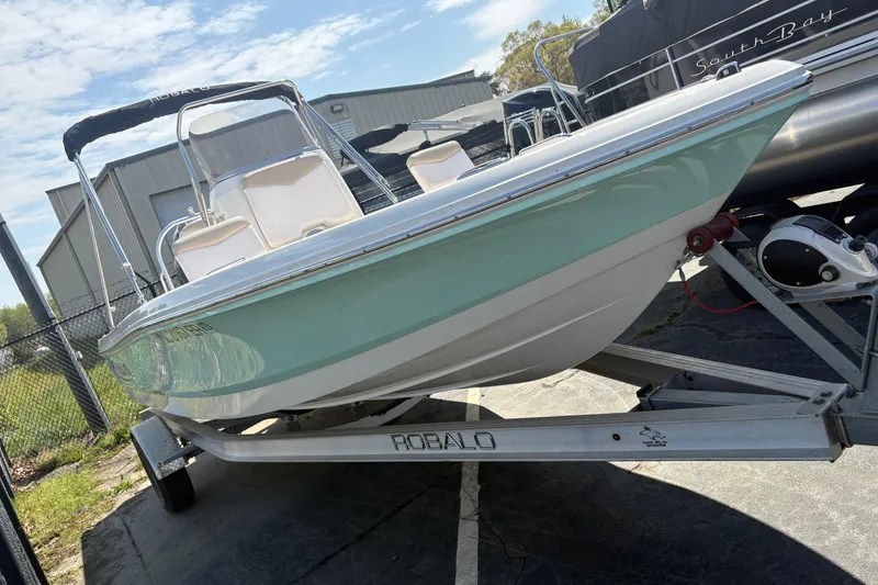 Slide: The Image of 2020 Robalo 206 Cayman boat on trailer, parked outdoors under clear sky. - 2