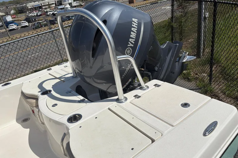 Slide: The Image of 2020 Robalo 206 Cayman boat with Yamaha outboard motor, docked near a fence. - 5