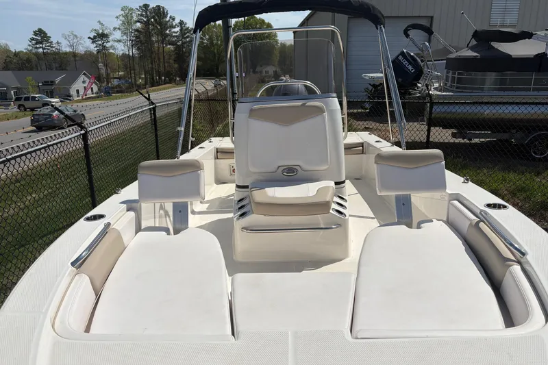 Slide: The Image of 2020 Robalo 206 Cayman boat interior with seating and console, parked outdoors. - 6