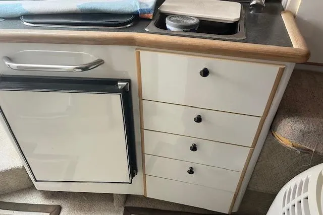 Slide: The Image of 1993 Maxum 2700 SCR boat kitchenette with fridge and drawers. - 11
