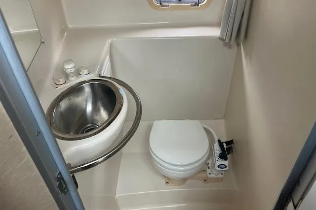 Slide: The Image of Compact bathroom in 1993 Maxum 2700 SCR boat with sink and toilet. - 12