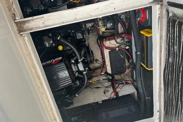 Slide: The Image of Engine compartment of a 1993 Maxum 2700 SCR boat, featuring a MerCruiser engine. - 13