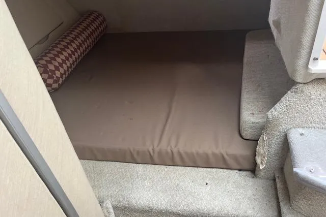 Slide: The Image of Interior cabin of 1993 Maxum 2700 SCR boat with brown mattress and patterned bolster pillow. - 15