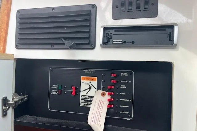 Slide: The Image of Control panel of a 1993 Maxum 2700 SCR boat with switches and warning label. - 16