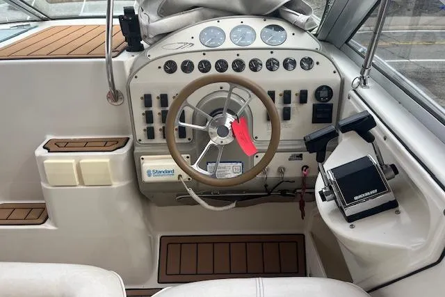 Slide: The Image of Cockpit of 1993 Maxum 2700 SCR boat with steering wheel and control panel. - 2